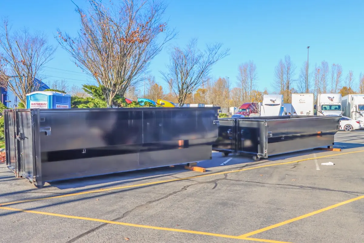 Professional dumpster rental service with roll-off container on residential driveway in Pensacola